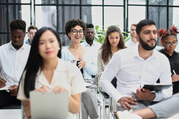 conducts business training with a group of young people.