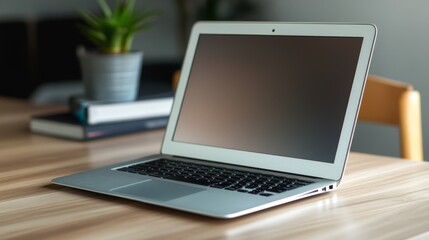 Fototapeta premium Modern laptop on wooden desk home office setup technology bright indoor environment close-up view productivity concept