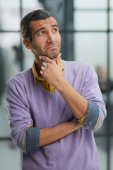 Portrait of businessman standing in office while working day