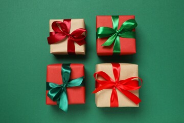Beautiful gift boxes tied with bows on color background 