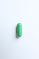 Green capsule on a white background
