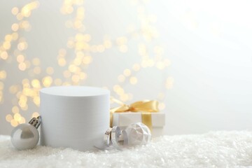 Beautiful composition with podium, Christmas decor and white snow 