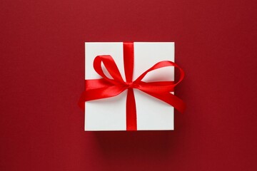 Beautiful gift boxes tied with bows on color background 