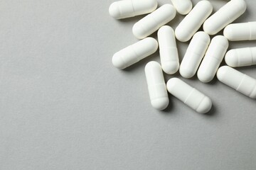 White capsules on a gray background