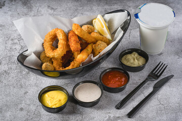Deep fried squid, shrimp and mussels with sauces on the side