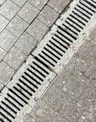 A drain pipe is shown in a grey and white color