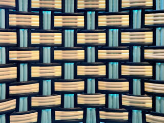 Close up of synthetic rattan or wicker weaving art in various pattern, blue, black, and white color. Rattan hand woven background seamless texture.