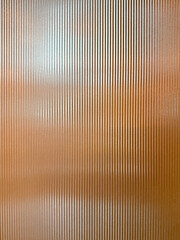 Texture of matt golden bronze fluted glass, or striped glass. Fluted glass is aesthetically...