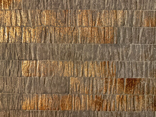 Unique rustic textured tiles in bronze brown color tone, glazed matt texture with gold metalic holographic accents. Seamless industrial golden brown tiles finish.