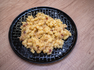 Cabbage dumplings are a traditional Slovak dish. The base consists of boiled gnocchi made from potato dough, which are mixed with steamed chopped sauerkraut and small pieces of fried bacon.
