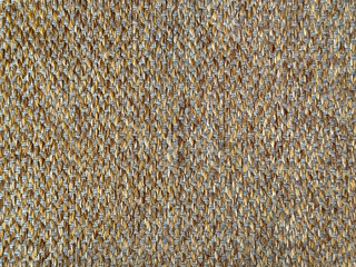 Close up texture of dark golden brown upholstery fabric, made of cotton and polyester. Suitable for sofa and soft seating. Seamless background fabric texture.