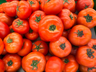 Close up of red tomatoes displayed on a local market. Tomatoes have been used often in any cooking and even made to juice.