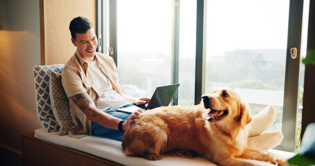 Happy, dog and man with laptop, home and patting of animal, smile and loyalty for owner in...