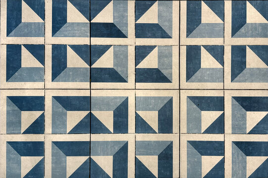 Abstract blue triangular cube geometric pattern painted on floor tiles. Blue modern mid century geometric pattern seamless background texture.