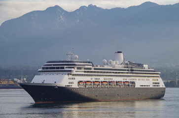 Classic luxury cruiseship cruise ship liner Volendam or Zaandam arrival into Vancouver, BC Canada after Alaska cruise with scenic harbor coast view and marine vessels