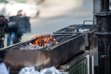 Meat Sticks on Barbecue For Street Food In The Center Of Singapore