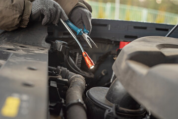 inspecting a car with flexible flashlight