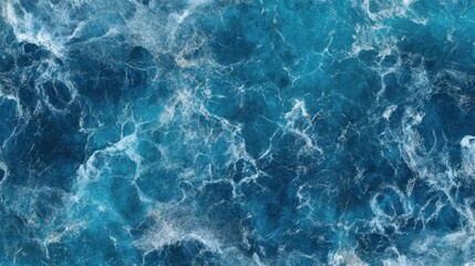 Fototapeta premium A stunning aerial view of a deep blue ocean, with frothy waves and wispy clouds dotting the horizon 