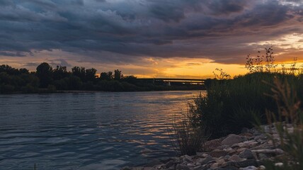 Naklejka premium River Bank with Forest and Dramatic Sunset Sky Under Dark Clouds Nature photography Image Isolated Evening Landscape Peaceful Background