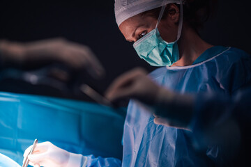 Focused surgeon during an intricate medical procedure in OR.