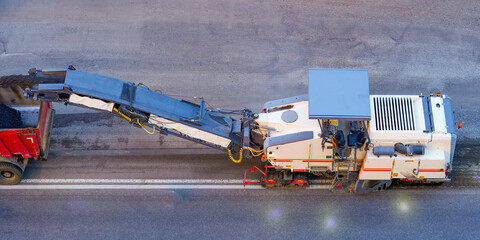 Asphalt removal repair using asphalt cutting and combine loading into truck body © aapsky