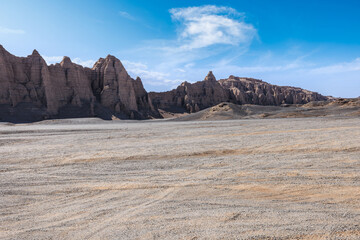 Desert sand road and Yardang landform mountain natural landscape in Xinjiang, China. Road trip in no man's land.