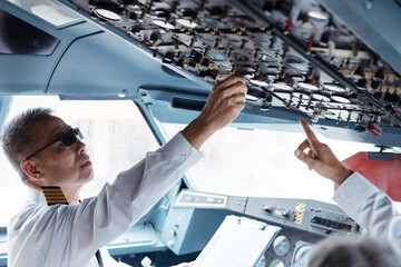 Successful serious airplane captain pilot preparing for flight at Airport.