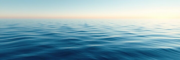 Fototapeta premium A vast expanse of blue water meeting the horizon at a soft creamy line where waves gently rock the surface with a soothing quality, natural, gentle