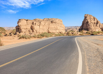 Asphalt road and Yardang landform mountain natural landscape in Xinjiang, China. Outdoor natural...
