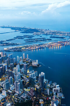 Aerial view of Miami skyline with skyscrapers at Downtown Brickell and Miami Beach at night portrait format in Miami, United States