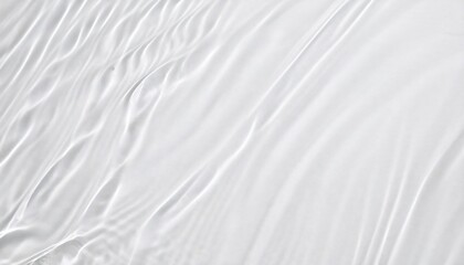 Obraz premium Subtle undulations disrupting the calm of a clear water surface, forming captivating interplays of light and darkness