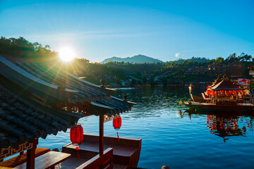 Sunset ambient at "Ban Rak Thai village" beside a beautiful lake with ancient chinese boat, a Village of Chinese settlement is a travel destination in Mae Hong Son province, unseen Thailand