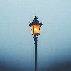 Elegant Vintage Lamp Post Illuminating a Foggy Evening Landscape, Casting a Warm Glow on a Serene Street Scene in the Depths of a Misty Atmosphere