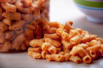 Macaroni snack spill creating delicious pile on table