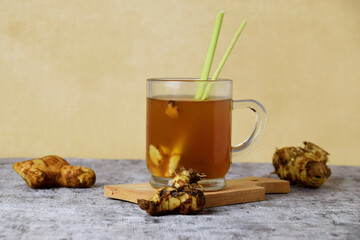 Healthy hot red ginger drink with a mixture of lemon and honey