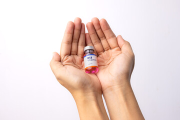 two hands showing a liquid vitamin b12 in the clinic room. health and medical concepts.