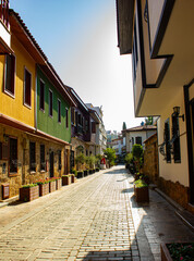 Narrow bright street with stores and cafes in the old town of city Antalya in Turkey