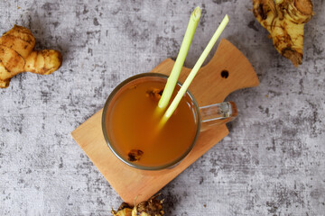Top view photo of a healthy hot red ginger drink with a mixture of lemon