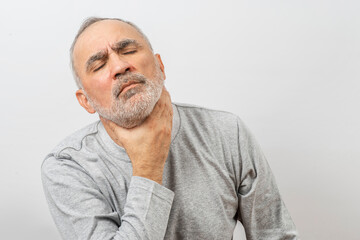 Mature man clutching his neck, throat. Complicated breathing, asthma or thyroid gland symptoms, suffering from throat pain..