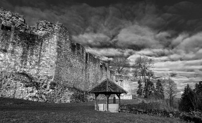 Ancient stone castle wall with wooden well.