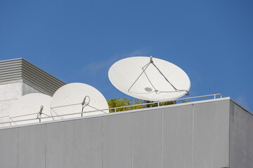 Satellite dishes pointing to the sky on building roof