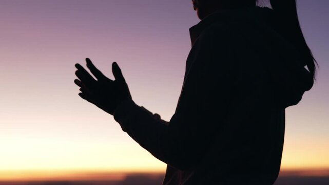 Silhouette of woman in intense prayer before betrayal and crucifix, gethsemane, prayer ministry.4k slow motion video.