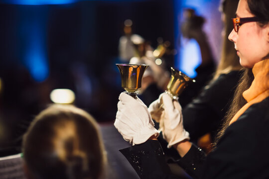 Musicians performing with handbells at a formal concert