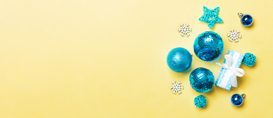 Top view of Christmas balls and creative decorations on colorful background with copy space. New Year concept