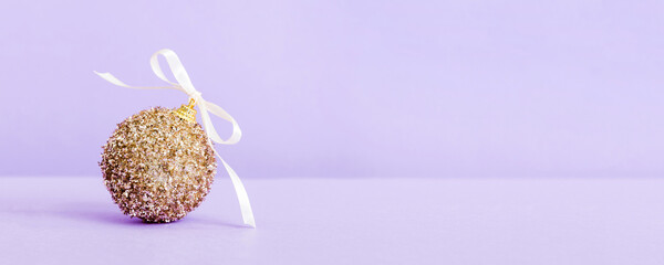 Christmas ball on colored background. decoration bauble with ribbon bow with copy space