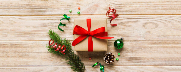 Top view Flat lay Christmas decorations and gift box on colored background with copy space. Christmas or Happy New Year composition