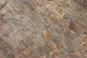 Natural rock background consiting of gray and ornage veins randomly on the surface