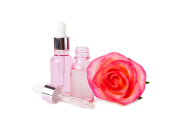 Rose essential oil isolated on white background.Roses and a bottle of rose perfumed water. Aromatherapy treatment. Beauty concept. Spa procedure.Natural organic oil.Anti-stress and detox relax.
