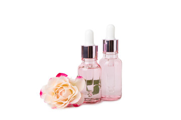 Rose essential oil isolated on white background.Roses and a bottle of rose perfumed water. Aromatherapy treatment. Beauty concept. Spa procedure.Natural organic oil.Anti-stress and detox relax.