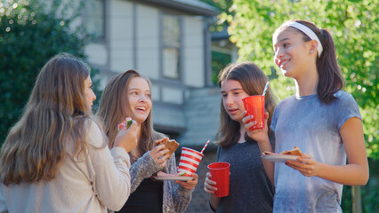  Teenage Girls At Outdoor Party Celebrating  In Garden Eating Pizza Together